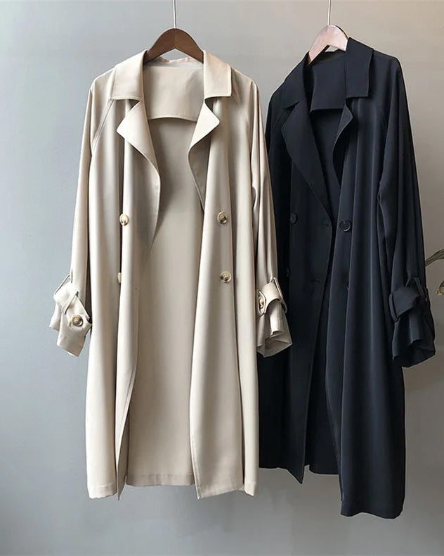 Elegant lightweight black trench coat with silky drape by Lumina Wear, shown on a model with classic collar and button details.