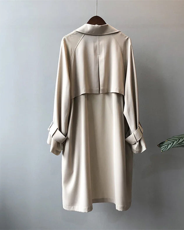 Elegant lightweight black trench coat with silky drape from Lumina Wear, featuring a sleek silhouette and stylish design.