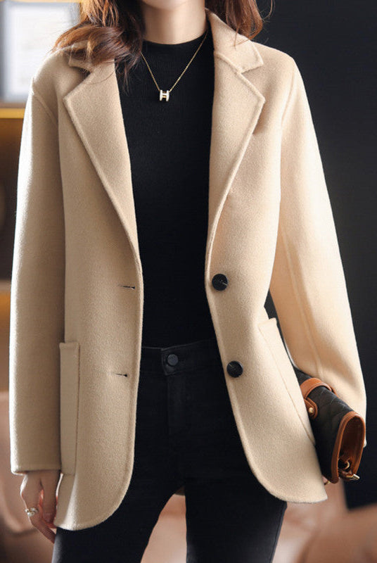 Light gray Valentina wool coat by Lumina Wear featuring a relaxed fit and classic lapel collar, displayed on a hanger.