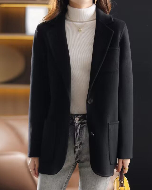 Valentina Lumina Wear elegant relaxed fit wool coat with lapel collar, shown in a neutral color on a model.
