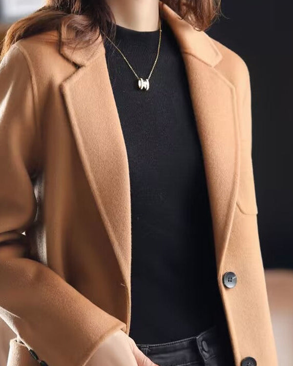 Valentina Lumina wool coat with relaxed fit and lapel collar, shown in a stylish, elegant design for women.