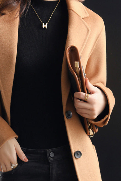 Elegant Lumina Wear Valentina wool coat with relaxed fit and lapel collar, displayed on a hanger in a neutral setting.