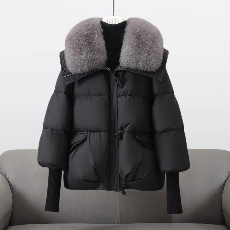 Extended-length black puffer jacket with fur collar from Lumina Wear, featuring a stylish design and warm, padded insulation.
