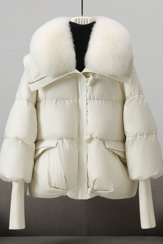 Black extended-length puffer jacket with fur collar by Lumina Wear, featuring a stylish winter design and quilted insulation.