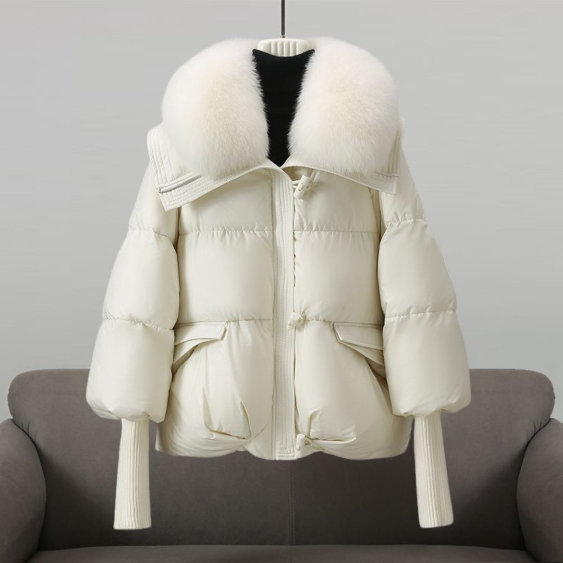 Black extended-length puffer jacket with fur collar by Lumina Wear, featuring a stylish winter design and quilted insulation.