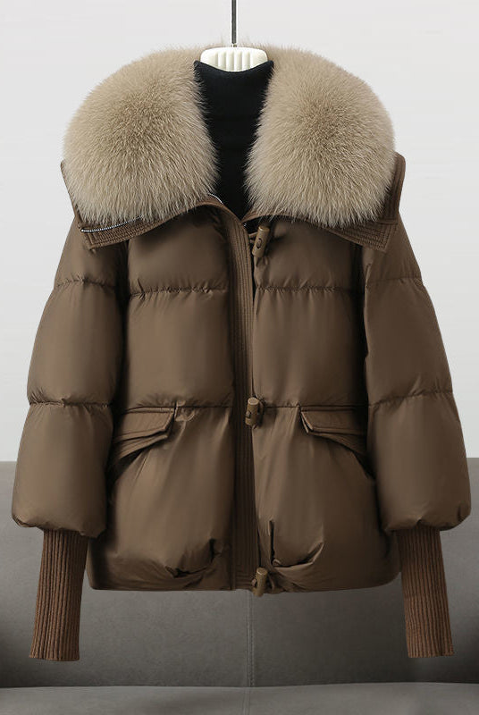 Black extended-length puffer jacket with fur collar by Lumina Wear, featuring a cozy, stylish design for cold weather.