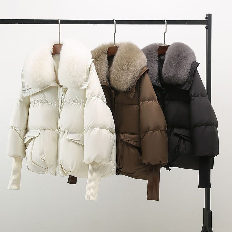 Black extended-length puffer jacket with fur collar from Lumina Wear, featuring a cozy, padded winter design.