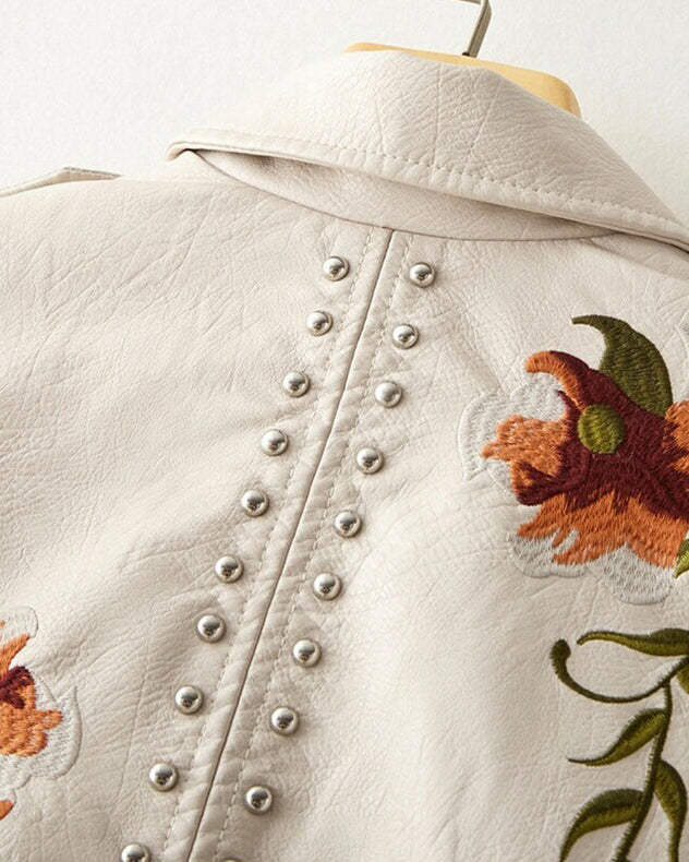 Valentina retro floral embroidered vegan leather jacket with stud accents from Lumina Wear, displayed on a hanger.