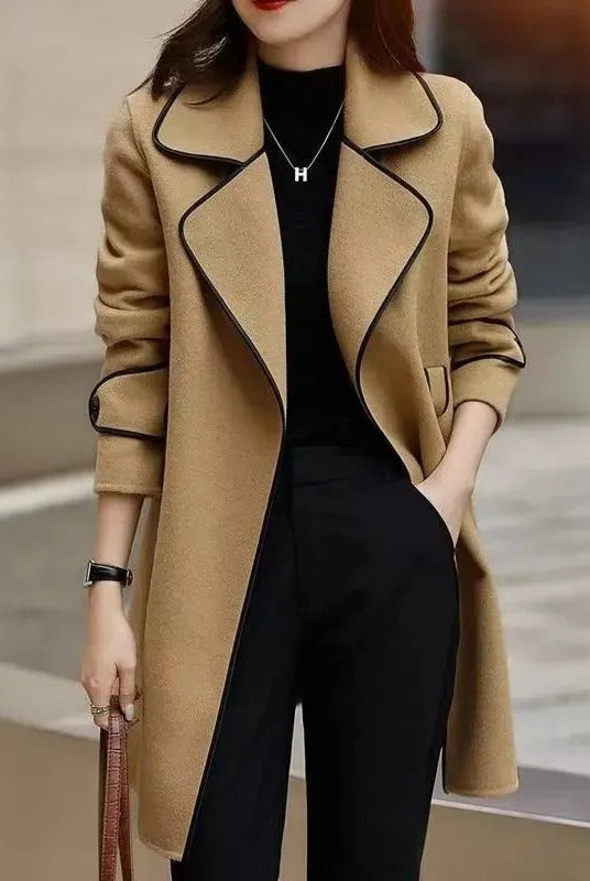 Black trench coat with contrast piping, elegant design, from Lumina Wear's Verona collection, showcased on a model.