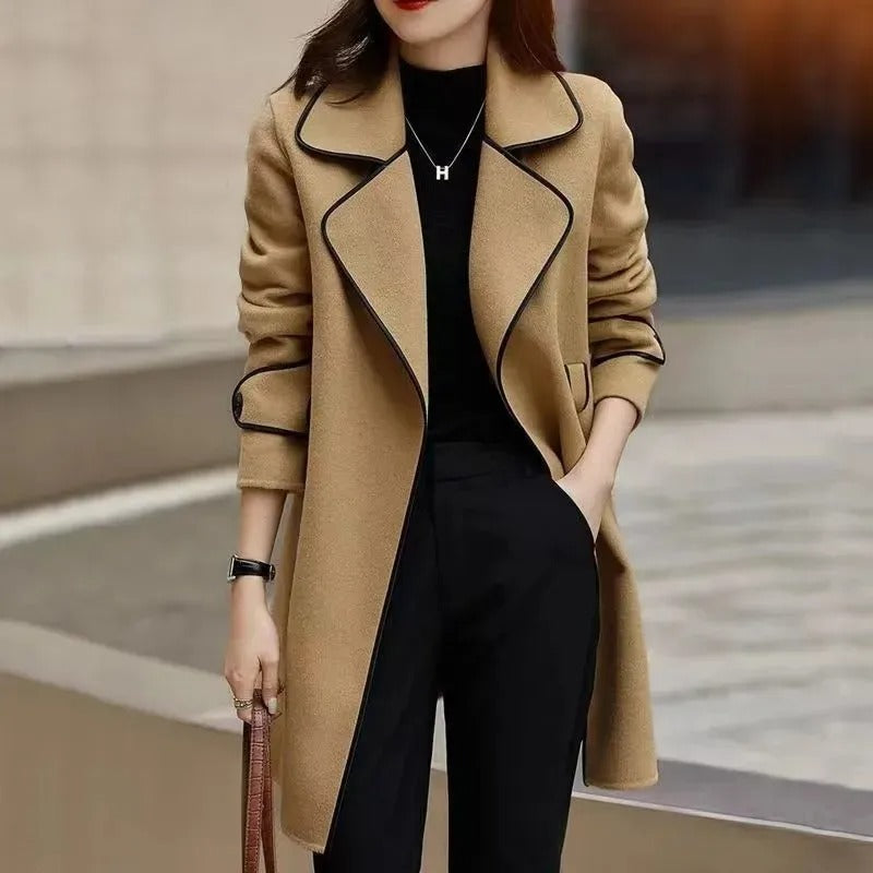 Black trench coat with contrast piping, elegant design, from Lumina Wear's Verona collection, showcased on a model.