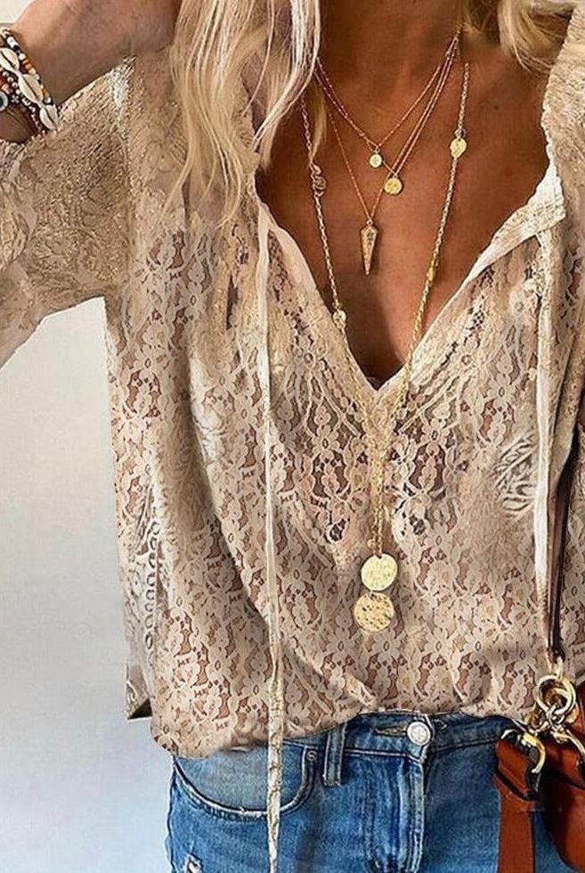 Lumina Wear Victoria bohemian V-neck blouse with decorative detailing, featuring flowy fabric and intricate embroidery.