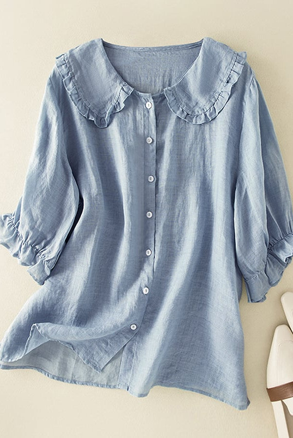 Light blue Victoria Lumina Women's relaxed fit ruffle collar top, perfect for effortless summer style, displayed on a hanger.
