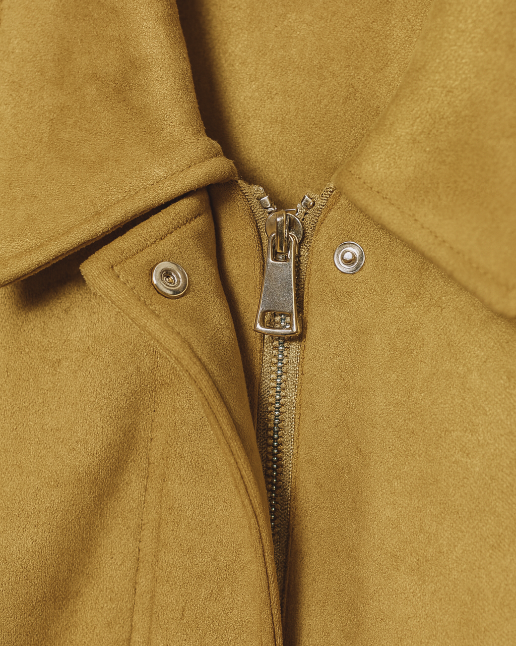 Yellow bomber jacket by Lumina Wear featuring trendy details and modern design, shown on a model with a casual urban background.
