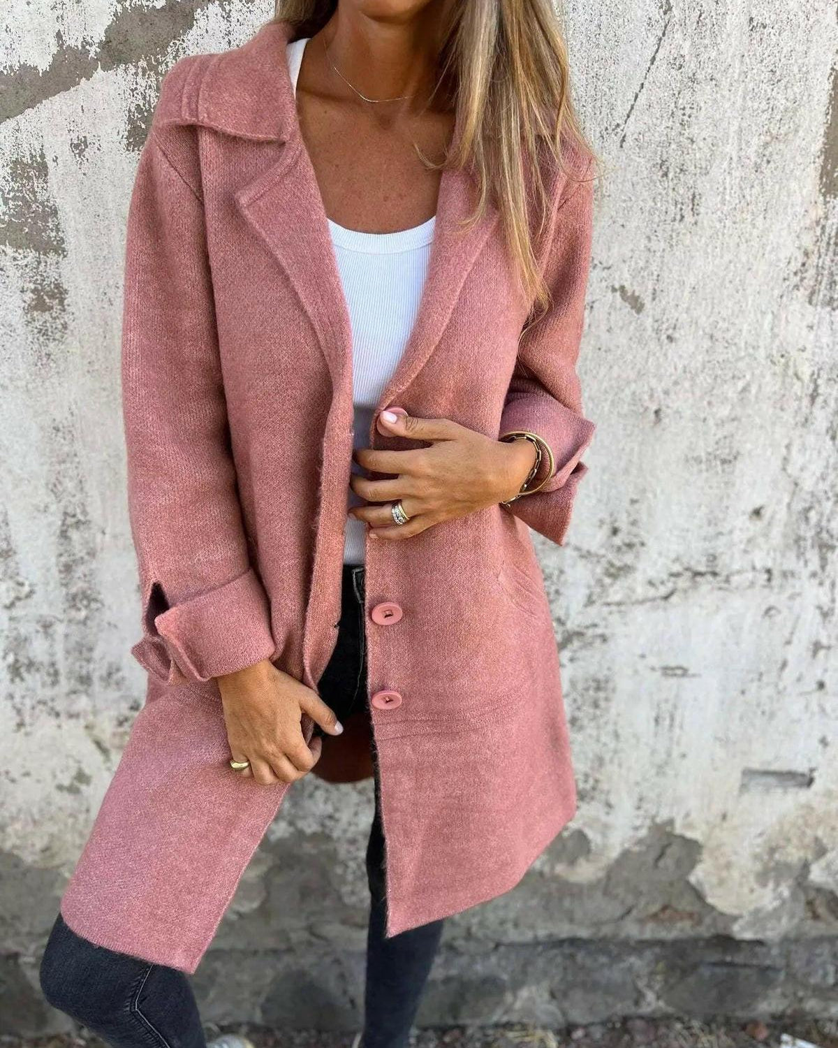 Green Lumina Wear Ada long knit coat with a stylish, cozy design, shown on a model in a city setting.