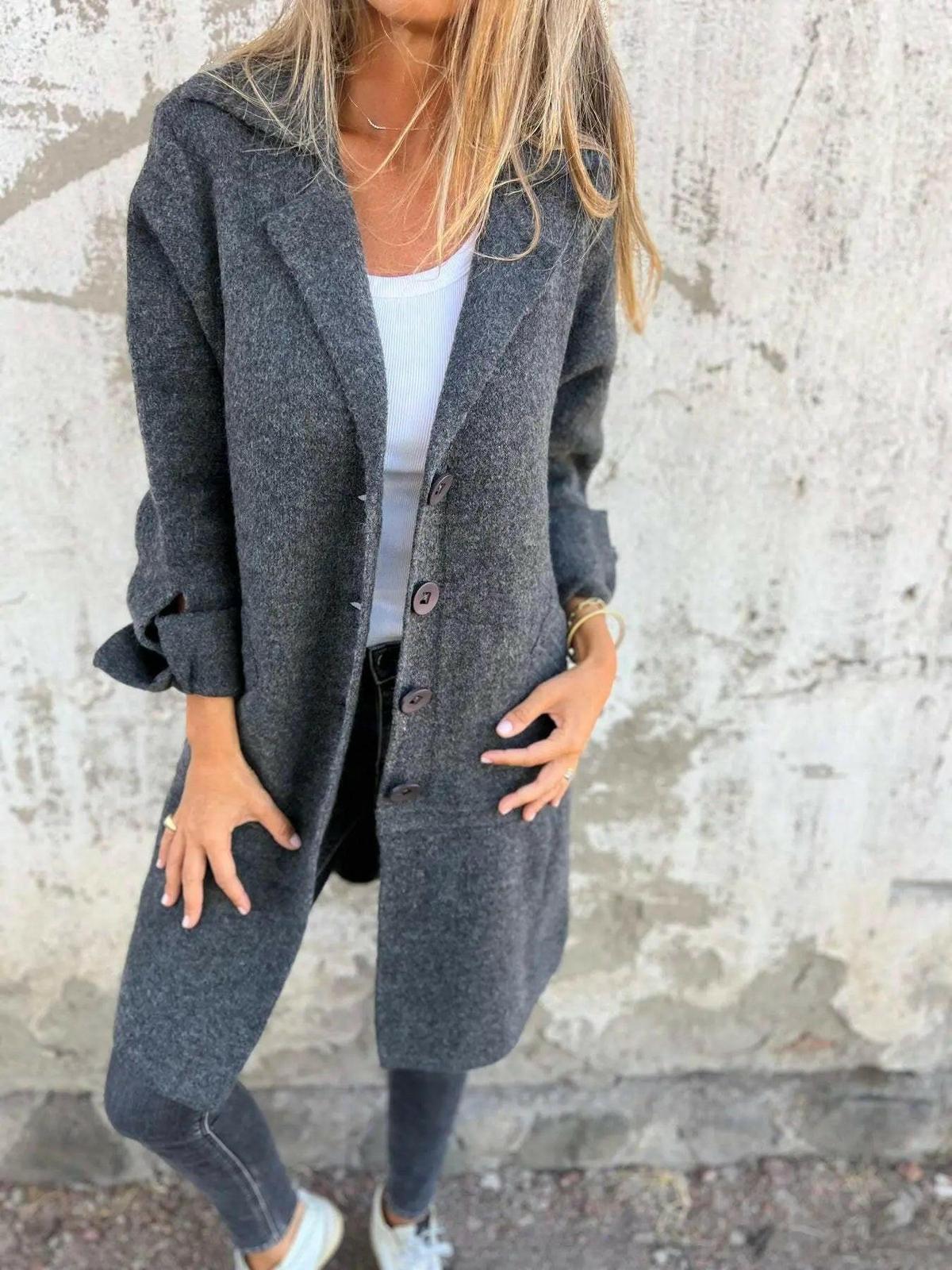 Green Ada™ stylish long knit coat by Lumina Vancouver, shown hanging with detailed knit texture and modern design.