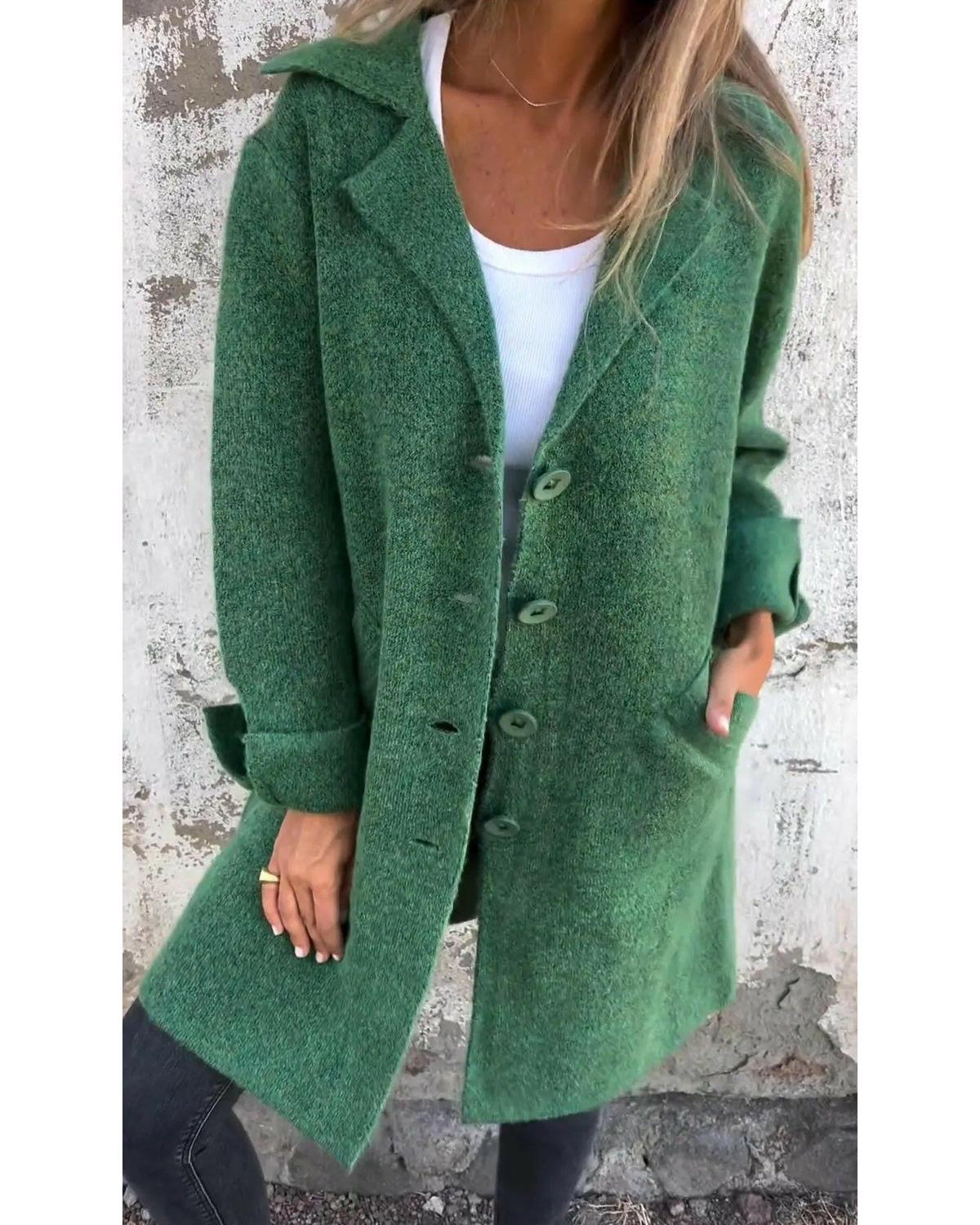 Green long knit coat by Lumina Wear, stylish and cozy, shown on a model in a casual outdoor setting.