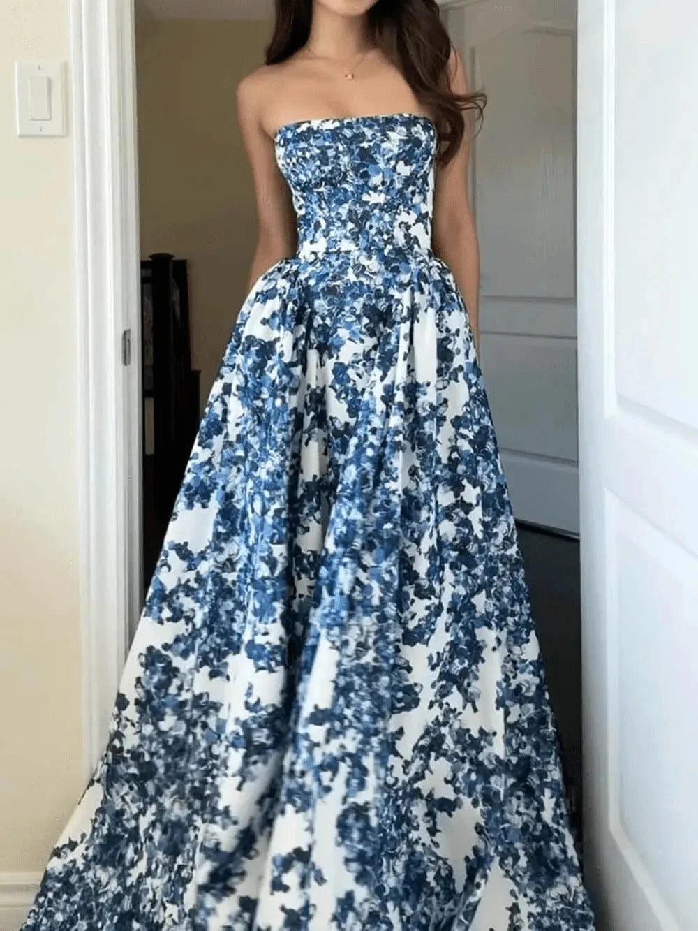 Blue Aitana floral gown by Lumina Vancouver, elegant wedding guest dress with intricate floral patterns and flowing fabric.