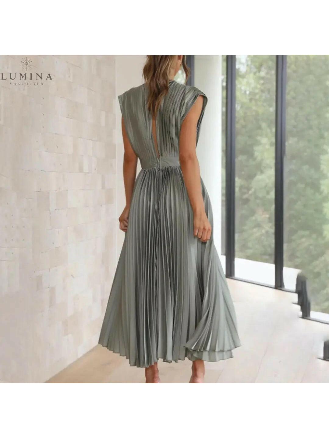 Alexia elegant champagne wedding guest dress by Lumina Vancouver, sleeveless with a fitted bodice and flowing skirt.