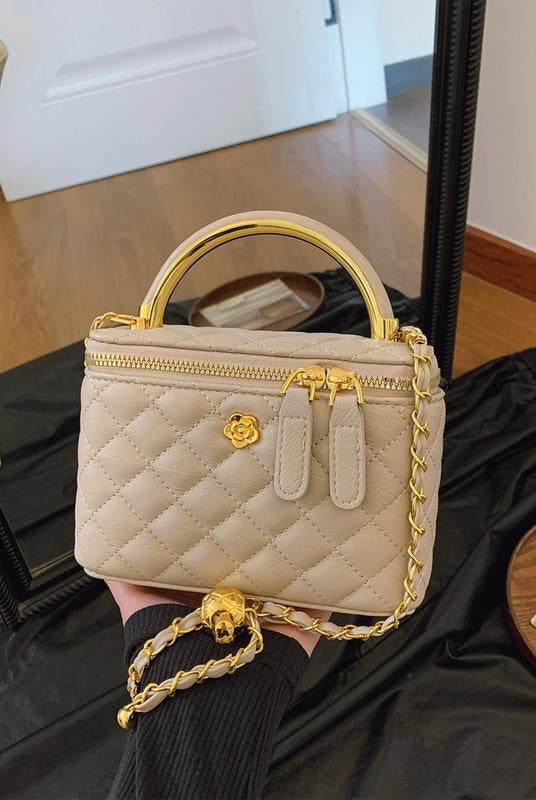 White Lumina Wear Alice quilted crossbody handbag with adjustable strap, featuring a stylish design and compact size.