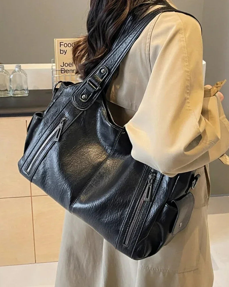 Black Lumina Wear Aliona backpack with versatile compartments, stylish design, and padded straps for school and everyday use.