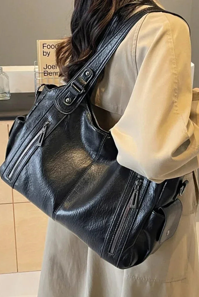 Black Lumina Wear Aliona backpack with multiple compartments and adjustable straps, stylish and versatile for school use.