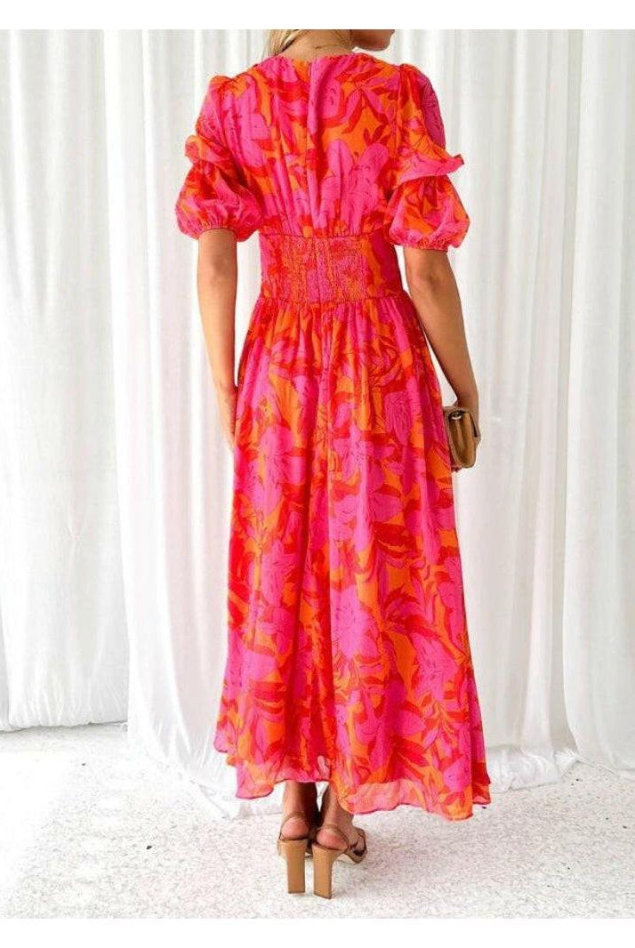 Red and pink V-neck puff sleeve maxi dress by Lumina Wear, featuring elegant design and flowing fabric.