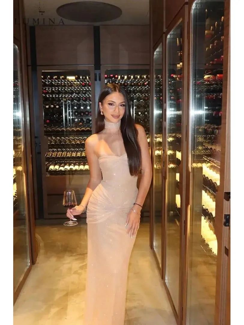 Girls wearing the Lumina Vancouver Amalia shimmer fishtail maxi dress for a stylish night out, featuring a fitted bodice and flowing skirt.