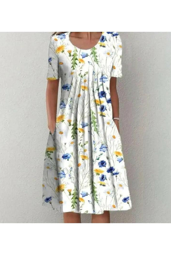 Red floral printed dress by Lumina Wear featuring a classic design, shown on a model with a flowing silhouette and elegant style.