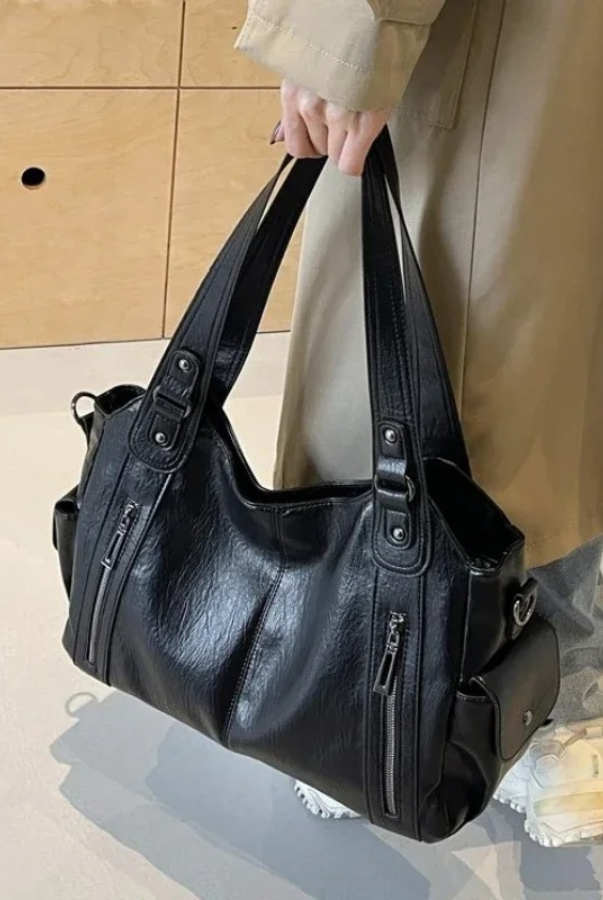 Amber black shoulder handbag by Lumina Wear featuring a sleek design and functional compartments, perfect for everyday use.