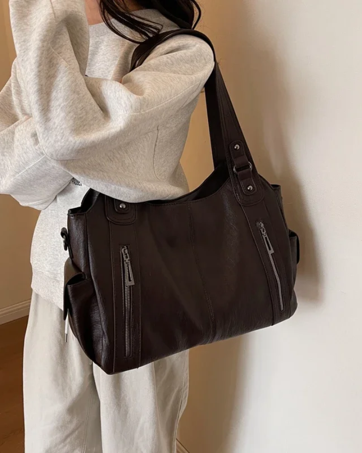 Elegant black Lumina Wear handbag with Amber shoulder bag design, featuring functional compartments and stylish shoulder strap.