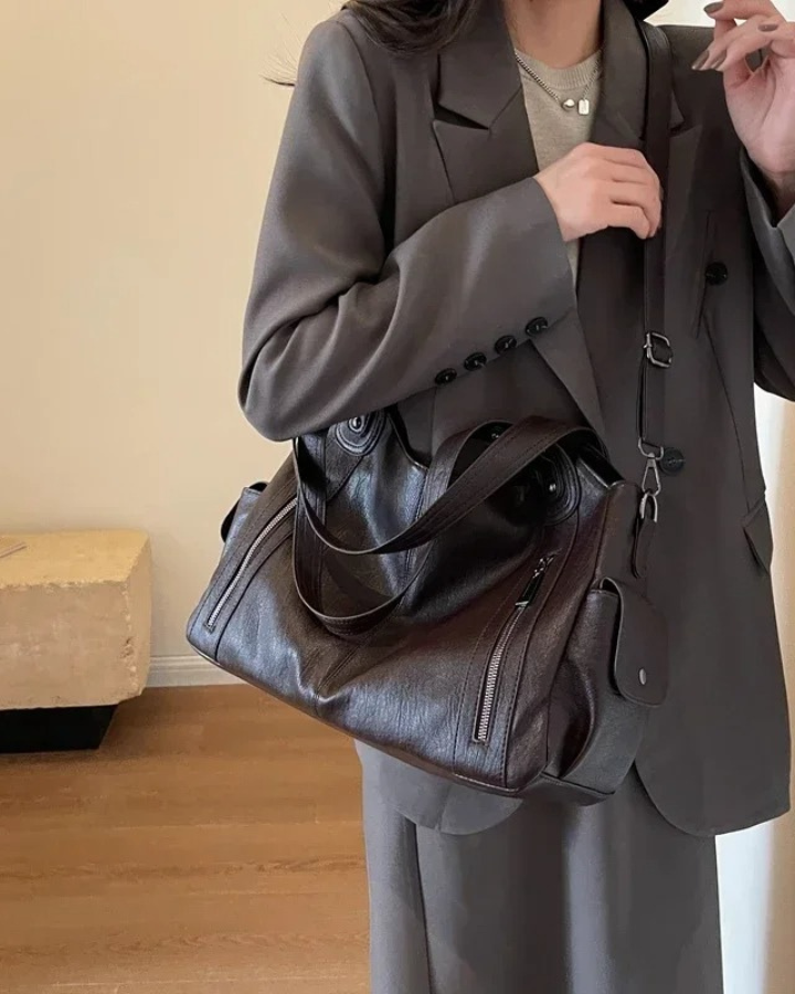 Amber Lumina black shoulder handbag with functional design, featuring sleek style and spacious interior for daily use.