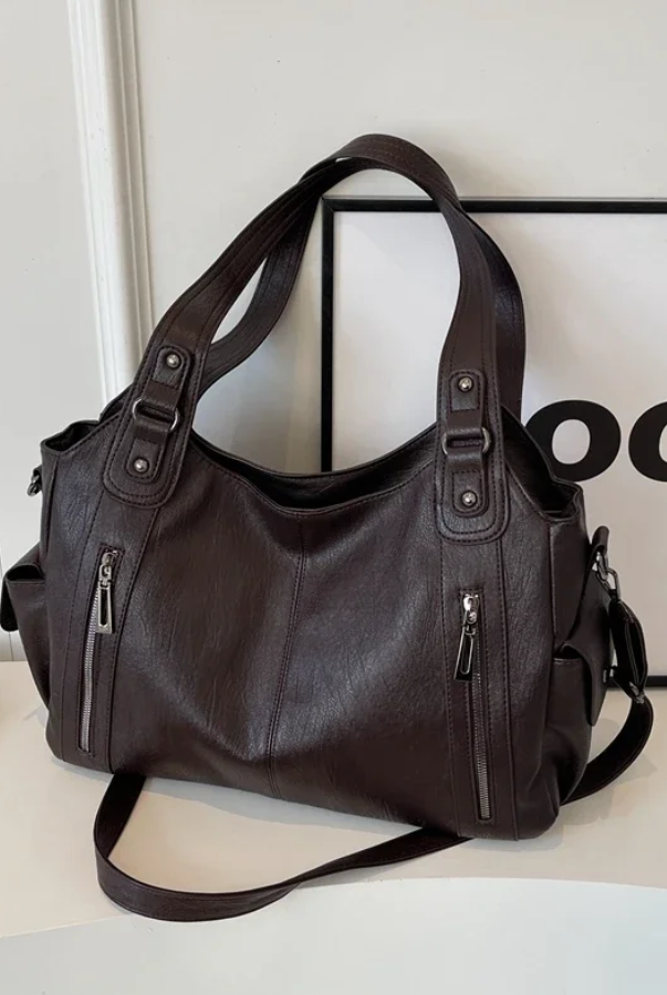Black Lumina Wear handbag with amber accents, elegant shoulder bag featuring a functional design and stylish look.