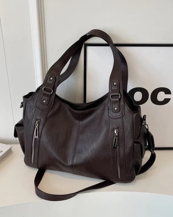 Amber black shoulder handbag by Lumina Wear featuring a sleek design and functional compartments.