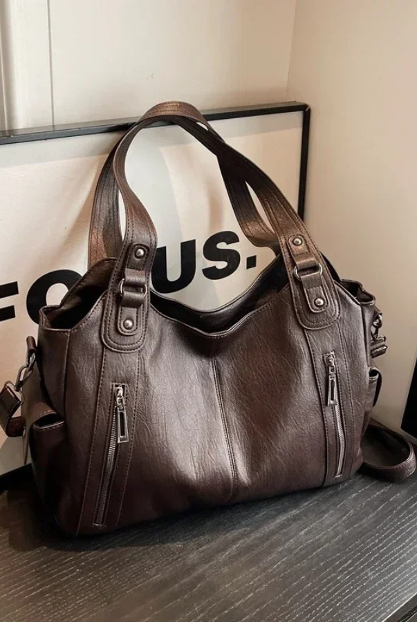Elegant black shoulder bag from Lumina Wear featuring functional design and Amber detailing, suitable for everyday use.