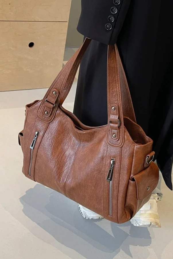 Elegant black shoulder handbag by Lumina Wear featuring functional design and Amber accents, perfect for stylish everyday use.