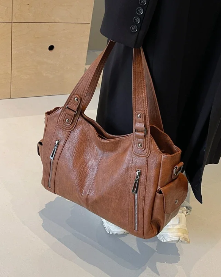 Elegant black Lumina Wear shoulder handbag with functional design, featuring a sleek Amber style with practical compartments.