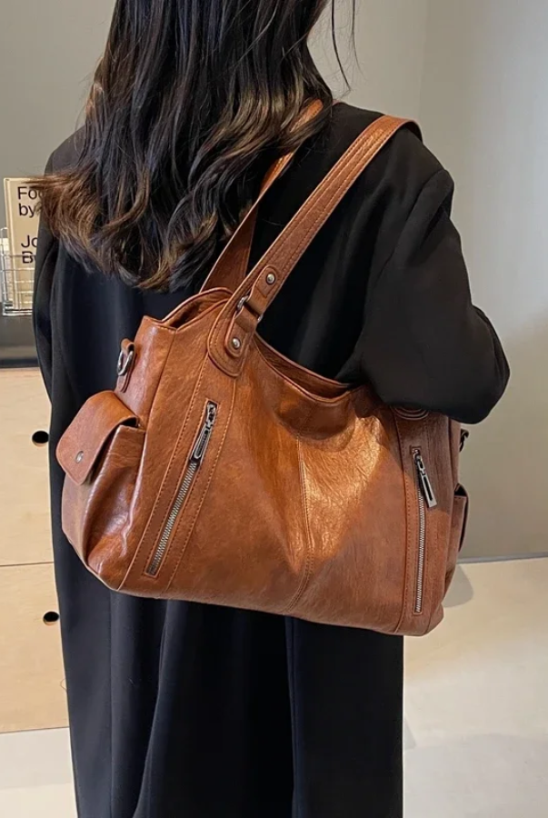 Amber black shoulder handbag by Lumina Wear featuring a sleek design and functional compartments for everyday use.