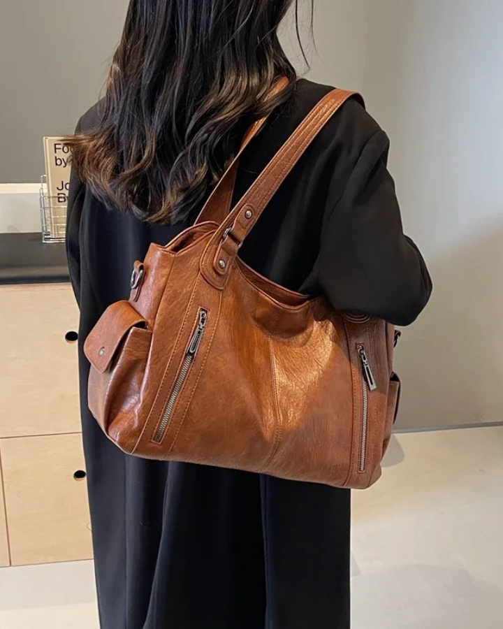 Amber black shoulder handbag by Lumina Wear, featuring a sleek design with functional compartments.