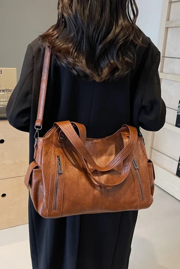 Elegant black shoulder bag by Lumina Wear featuring a functional design and Amber accents, ideal for stylish everyday use.