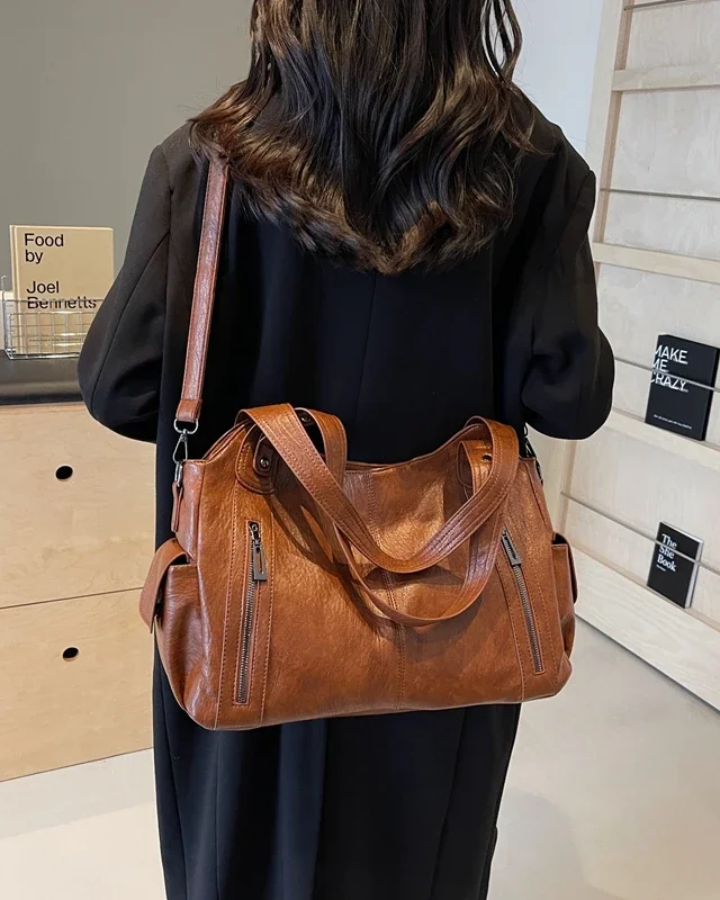 Amber black shoulder handbag by Lumina Wear featuring a sleek design and functional compartments.