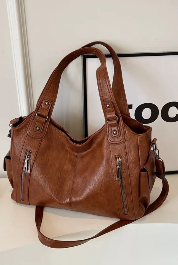 Amber black shoulder handbag by Lumina Wear featuring sleek design and functional compartments.