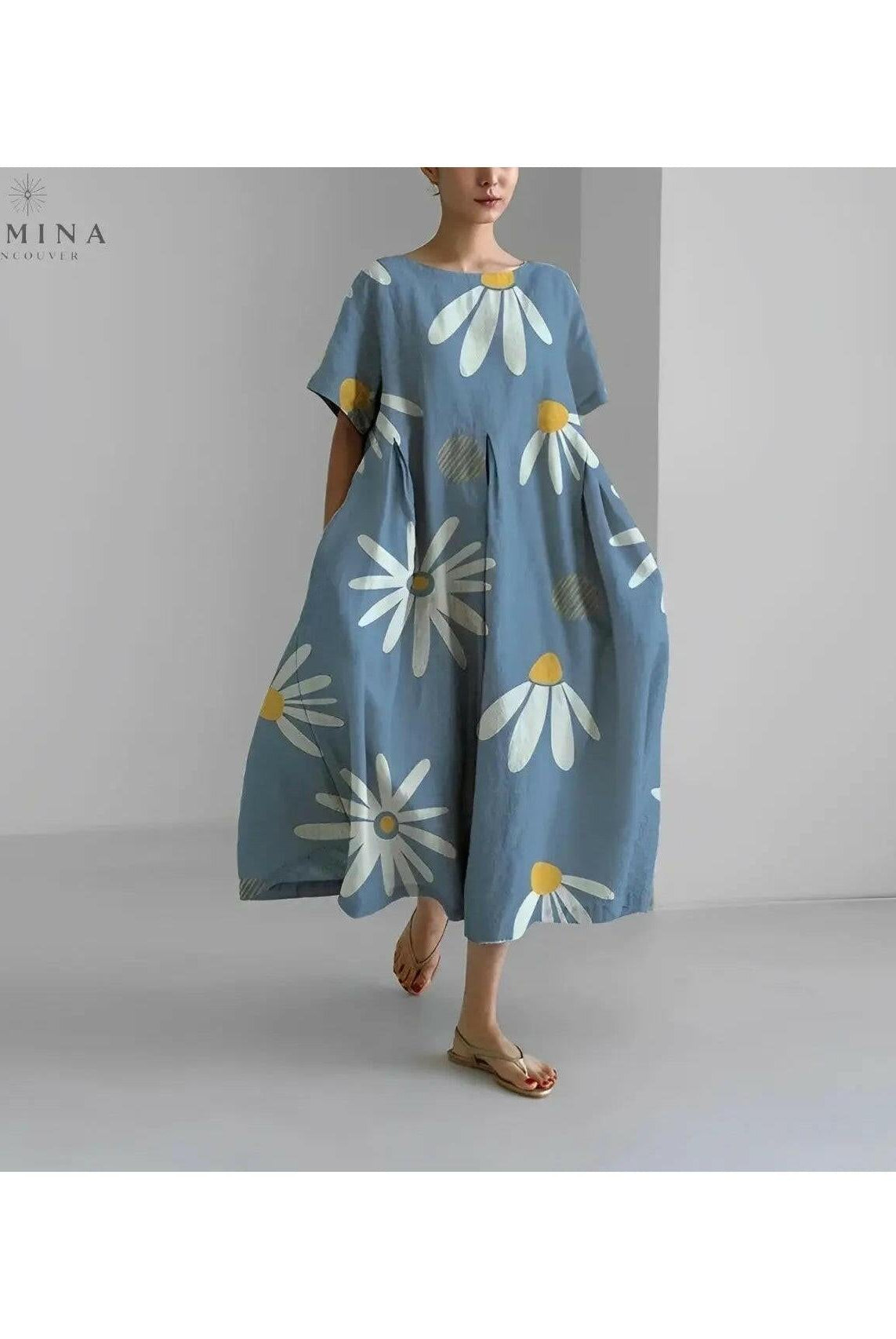 Lumina Wear Amelia floral dress featuring a colorful flower pattern and a flowing, lightweight fabric.