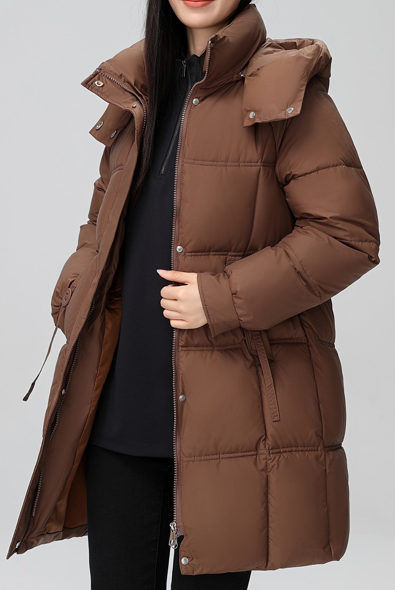 Black Amelia Lumina Wear hooded longline puffer coat with belt, stylish winter outerwear with quilted design and cozy fit.