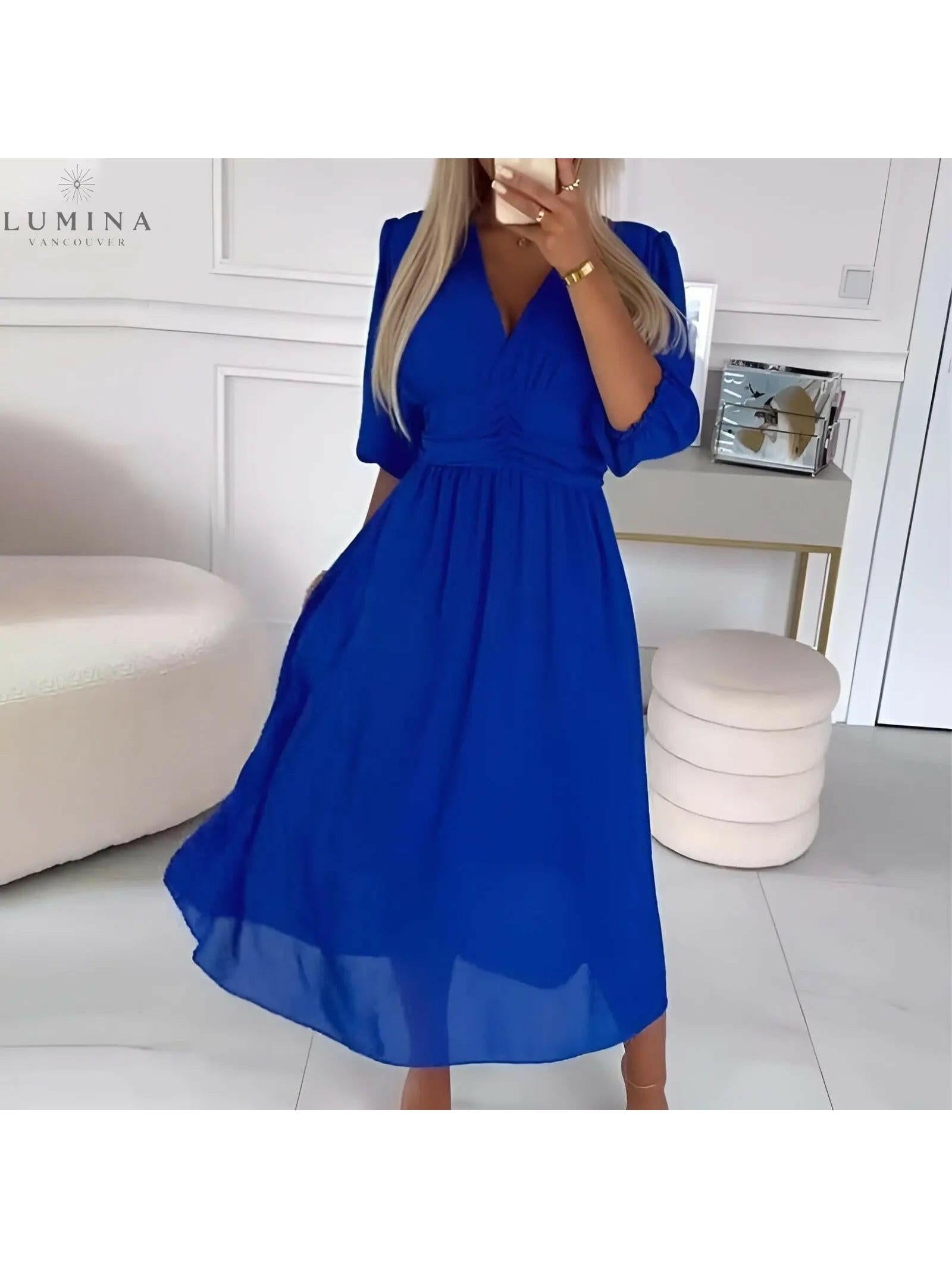Blue Ana stylish wrap dress by Lumina Vancouver, perfect for wedding guests, featuring elegant design and flattering fit.
