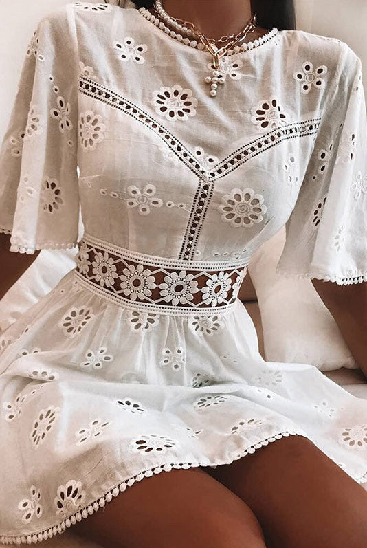 Arabella Celestine white eyelet mini dress by Lumina Vancouver, featuring a fitted silhouette and delicate eyelet fabric.