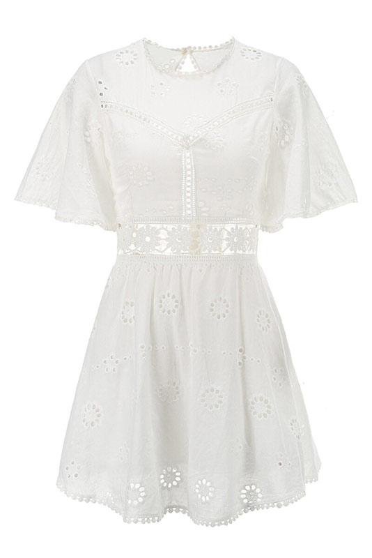 Arabella Celestine white eyelet mini dress by Lumina Vancouver displayed on a mannequin, showcasing delicate eyelet details and fit.