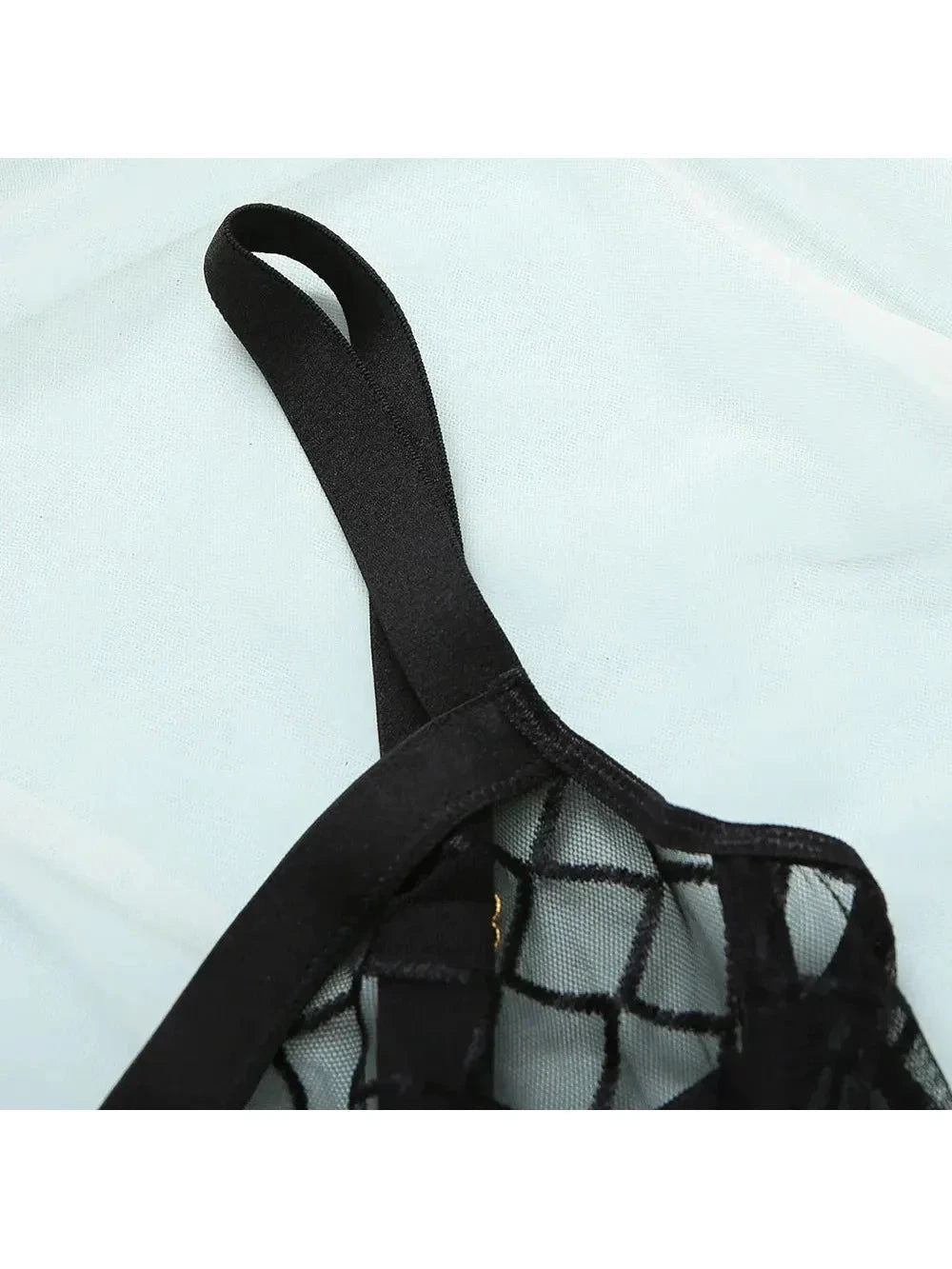 Lumina Vancouver Aria bodysuit in black, fitted with long sleeves and scooped neckline, displayed on a mannequin.