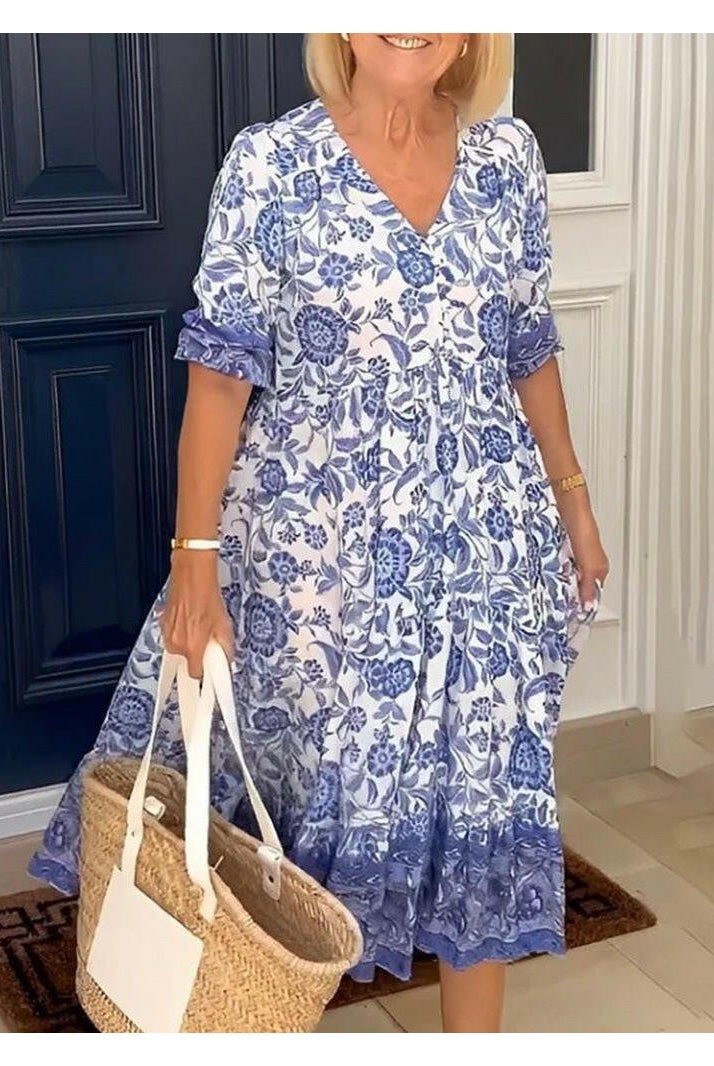 Blue Lumina Wear ARIA floral dress with V-neck, elegant design, showcasing the dress's pattern and neckline detail.