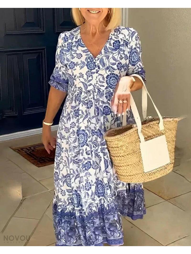 Blue ARIA™ floral dress with V-neck from Lumina Vancouver, featuring elegant design and intricate floral pattern.