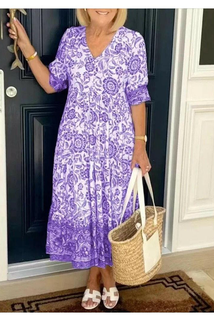 Blue Lumina Wear ARIA floral dress with V-neck, elegant design, showcasing the dress's intricate floral pattern and neckline.